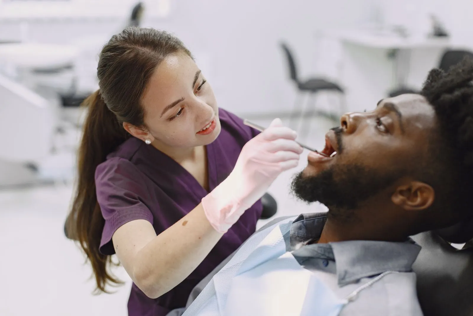 Dentist examining a patient with a mouth mirror